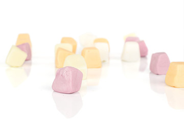 Lot of whole light soft pastel candy isolated on white background