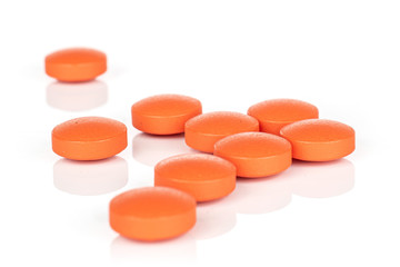 Group of nine whole orange tablet pharmacy isolated on white background