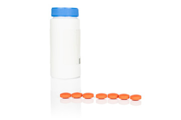 Group of seven whole orange tablet pharmacy with plastic bottle isolated on white background