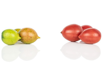 Group of six whole fresh tomato de barao isolated on white background