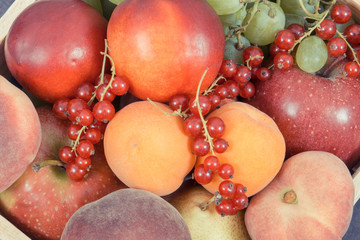 Fresh ripe fruits in wooden box. Food containing healthy minerals and vitamins