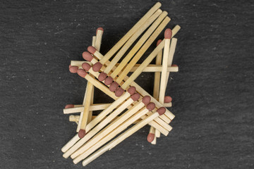 Lot of whole wooden brown safety match flatlay on grey stone