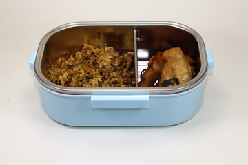 Clean food in heat storage lunch box. Healthy menu for diet. Grilled (Roasted) breast chicken with fried rice and egg.
