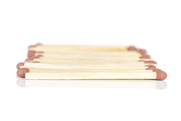 Lot of whole brown safety match in row isolated on white background