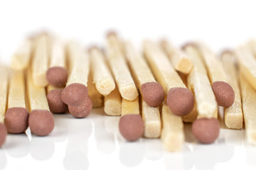 Lot of whole brown safety match closeup isolated on white background