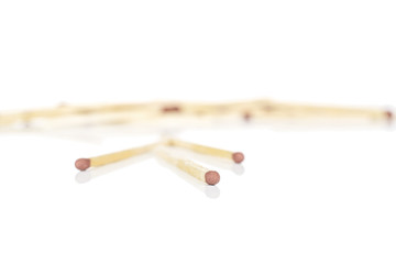Lot of whole wooden brown safety match three in focus isolated on white background