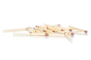 Lot of whole wooden brown safety match heap isolated on white background