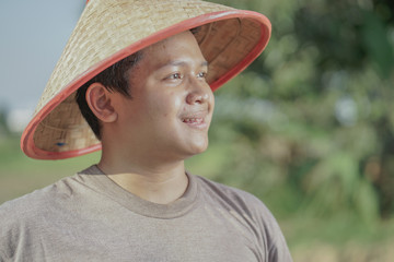 Close up Happiest Asia farmer harvesting rice in the field rice of Indonesia.