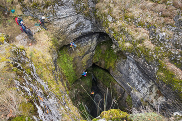 Sumgan-Kutuk karst cave. Cavers descend into the cave.