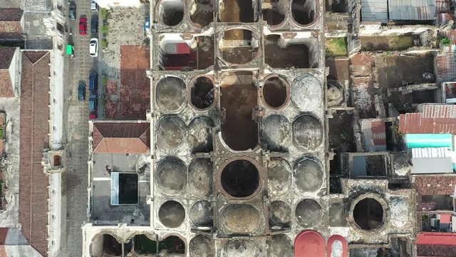 Aerial Drone view of Antigua in Guatemala. Flying forward over Unesco protected Catedral de Santiago destroyed by earthquake and Antigua main square Parque Central. 