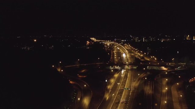 Aerial, drone shot, towards a Junction at the on road 51, Lansi-vayla and Keha 1 intersection, on a dark, autumn night, in Espoo, Uusimaa, Finland