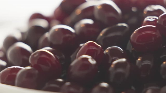 Pile of fresh ripe cornelian cherrie on a plate rotating.