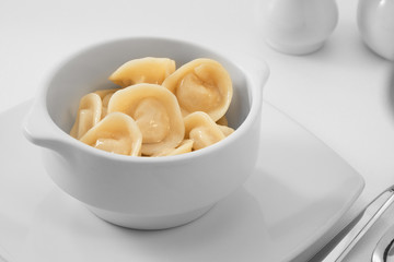 close up view of plate with dumplings  on white background.