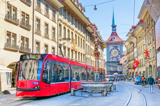 Streets with shopping area and Zytglogge astronomical clock tower and fountain in the historic old medieval city centre of Bern, Switzerland