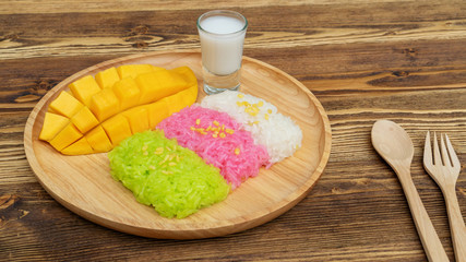 Three colors of sticky rice and ripe mango (Thai dessert).