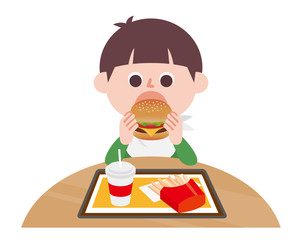 Boy eating hamburger