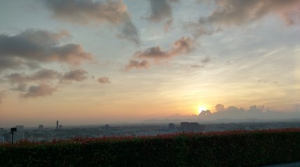 Fototapeta premium sunrise slowly rise up , hidden by the cloud