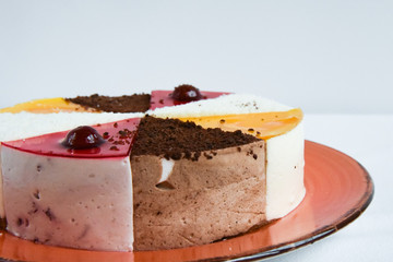 Cake with colorful triangles, close-up. Cherry. pastry