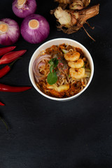 Penang Laksa Noodle Soup flat lay with ingredients on a black table