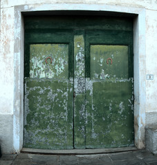 Faded workshop doors in Fornacette, Tuscany