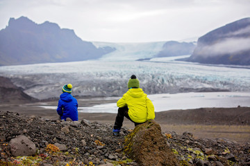 Children posing in beautiful aerial view of the nature in Skaftafell Glacier national park on a...