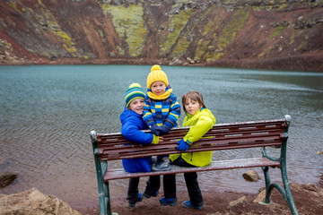 Children, boys, posing in front of Kerid crater lake in Iceland © Tomsickova