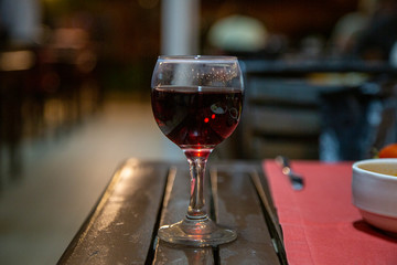 glass of red wine on wooden table
