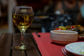 glass of white wine on wooden table