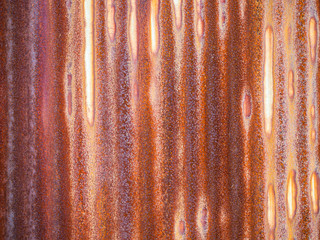 Abstract and closeup of rusty old dirty aluminium zinc sheet wall texture and background with vertical striped pattern.