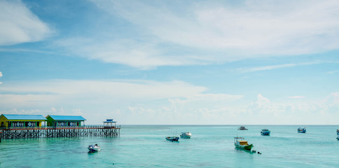 beautiful scenery at Derawan Island. Boats docked in the port with crystal clear water