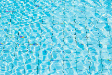Water surface in blue swimming pool