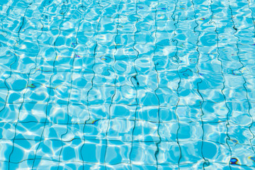 Water surface in blue swimming pool