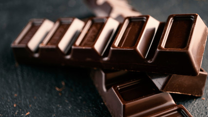 Chocolate bars close-up on concrete.