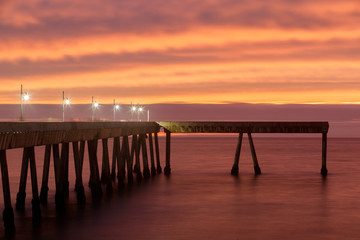 Fototapeta na wymiar Fiery Sunset over Pacifica Municipal Pier. Pacifica, San Mateo County, California, USA.