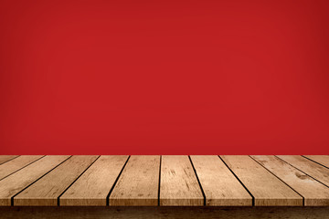 Empty wooden table top on pastel red colour background. Used for halloween or black friday display...