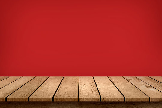 Empty wooden table top on pastel red colour background. Used for halloween or black friday display or montage your products.
