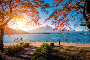 Mt. Fuji over Lake Kawaguchiko with bicycle and autumn foliage at sunrise in Fujikawaguchiko, Japan.