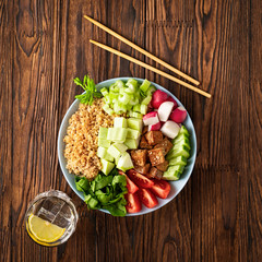 vegetarian poke bowl with vegetables and quinoa on a wooden table. Healthy food, vegetarian food. Buddha plate