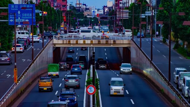 A timelapse of downtown street at Kanpachi avenue in Tokyo daytime long shot tilt
