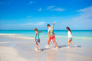 Happy family on the beach during summer vacation