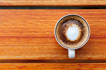 Coffee cup top view on wooden table background