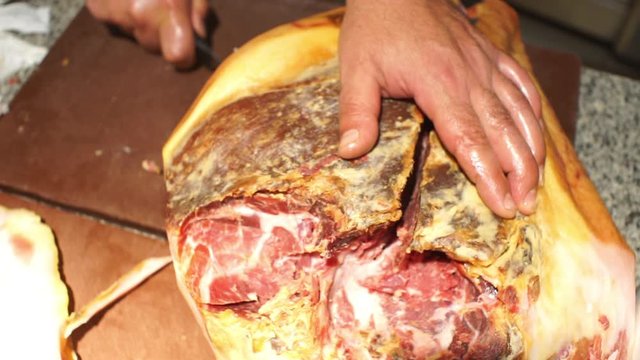 Close up footage of cook preparing a prosciutto
