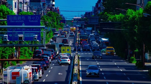 A timelapse of downtown street at Kanpachi avenue in Tokyo daytime long shot tilt