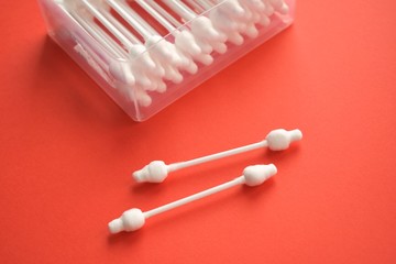 cotton swabs, sticks for cleaning ears, cotton swabs white on a red background