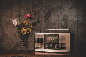 Still life with a retro radio receiver and flower vases.