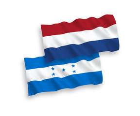 National vector fabric wave flags of Honduras and Netherlands isolated on white background. 1 to 2 proportion.