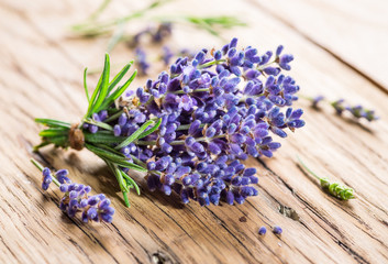 Bunch of lavandula or lavender flowers on the wooden background.