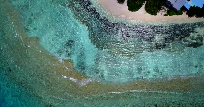 Aerial view vertical of colorful coral band around tourist resort in San Blas Island