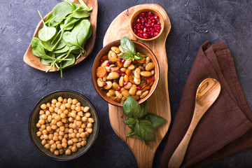 Spicy Chickpea and beans curry Chana Masala in bowl on stone  table. Traditional Indian dish. Top view.
