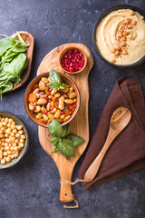 Mediterranean mezze board with  hummus, kidney beans, spinach . top view